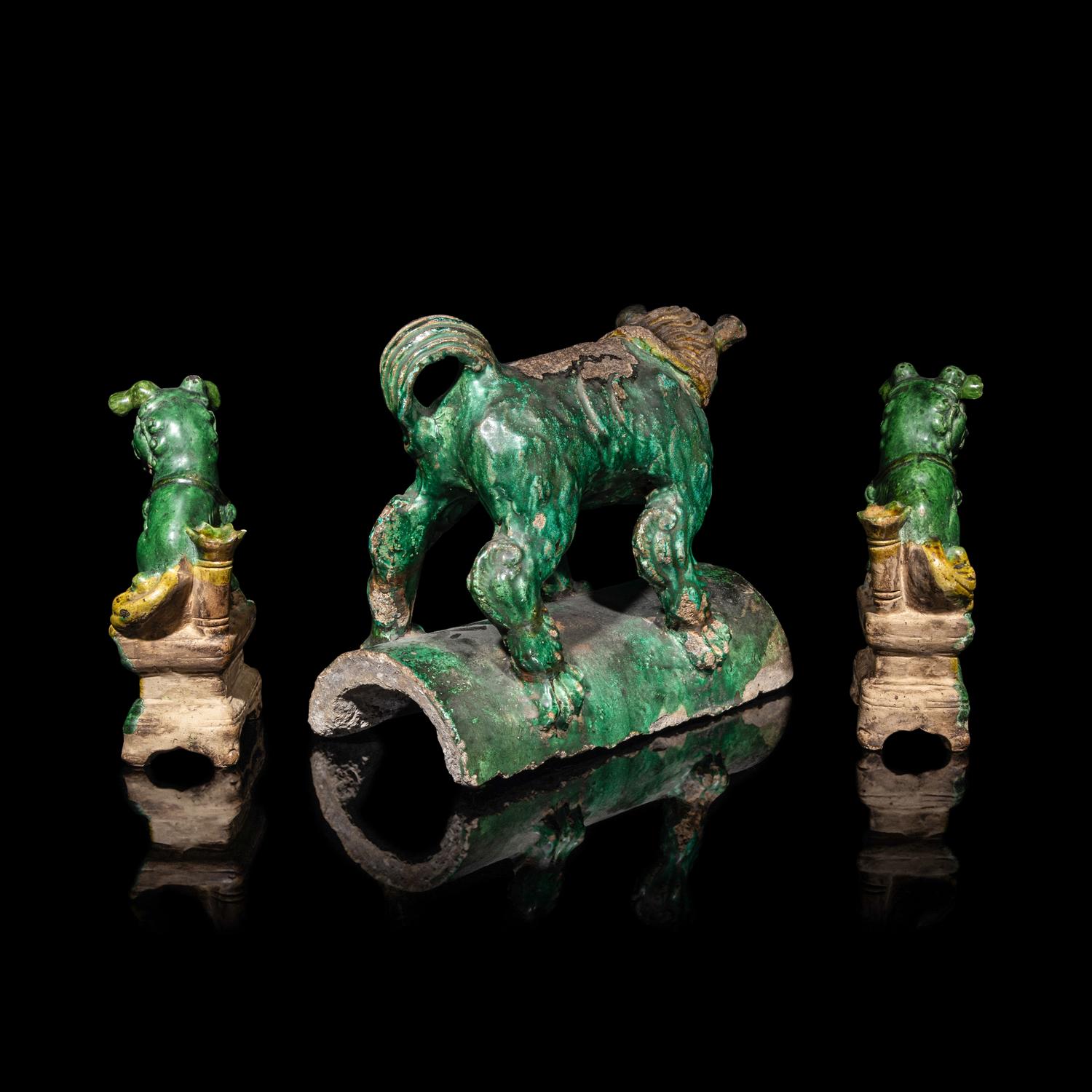 A Chinese Sancai Glazed ' Lion' Roof Tile and a Pair of Figures of Lions, Ming Dynasty 明 素三彩佛獅瓦當及佛獅像一對