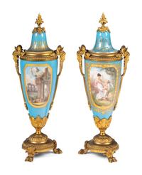 A Sèvres Style Porcelain and Gilt Bronze Mounted Three-Piece Clock Garniture