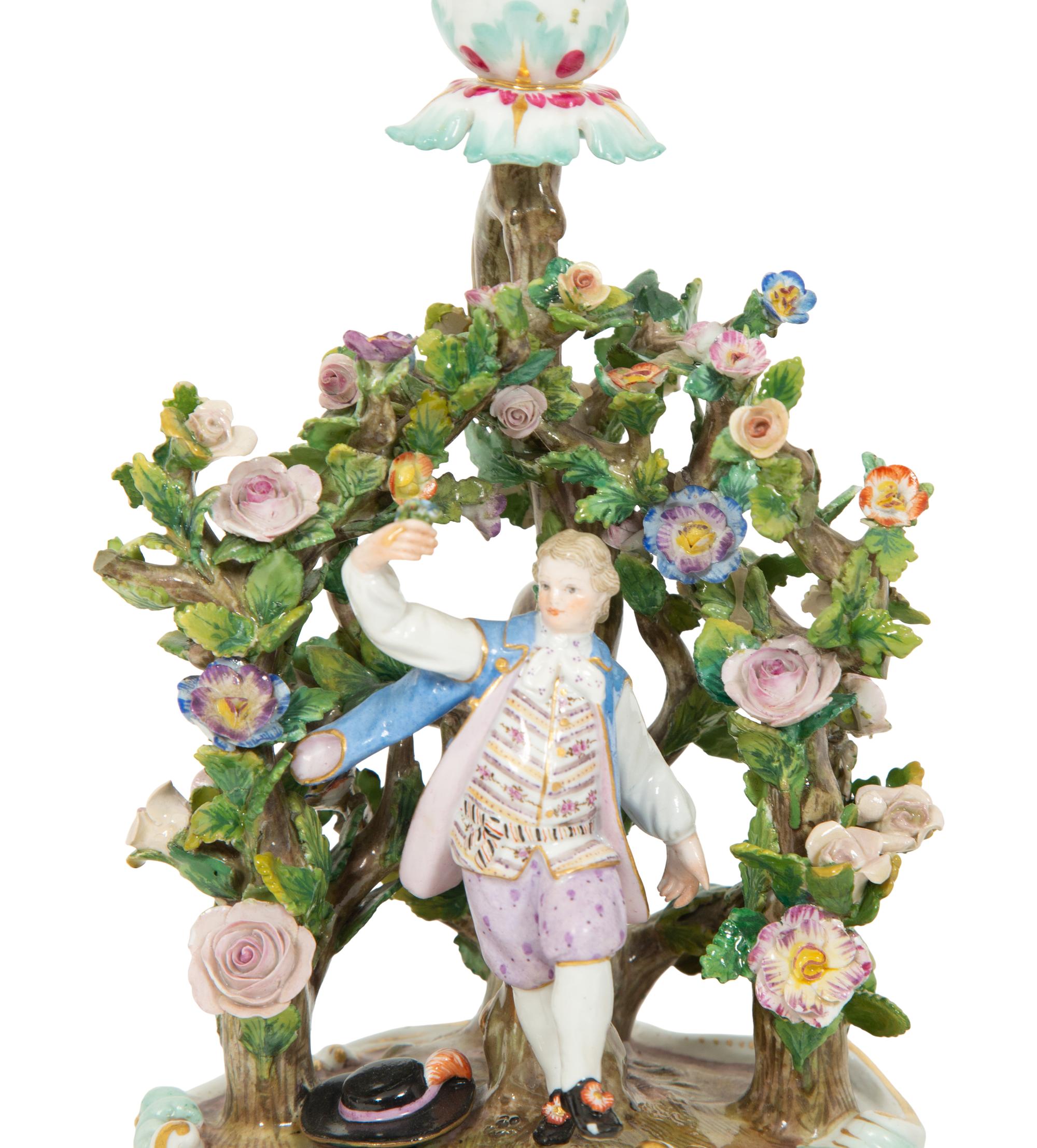 A Pair of Meissen Porcelain Figural Candlesticks with Floral Arbors