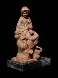 A Greek Terracotta Seated Scholar Holding a Wine Jug