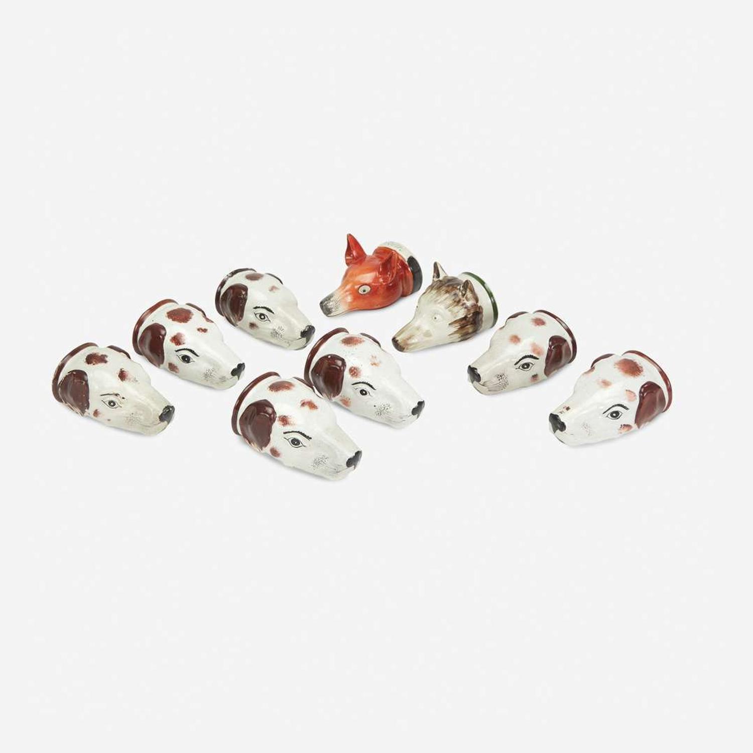 A Group of Nine English Pearlware Fox and Hound Stirrup Cups 19th/ early 20th century