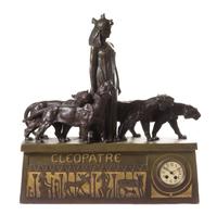 An Egyptian Revival Parcel Gilt Terra Cotta Figural Mantel Clock Height 28 x width 27 x depth 7 inches. — FRENCH, 19TH/20TH CENTURY