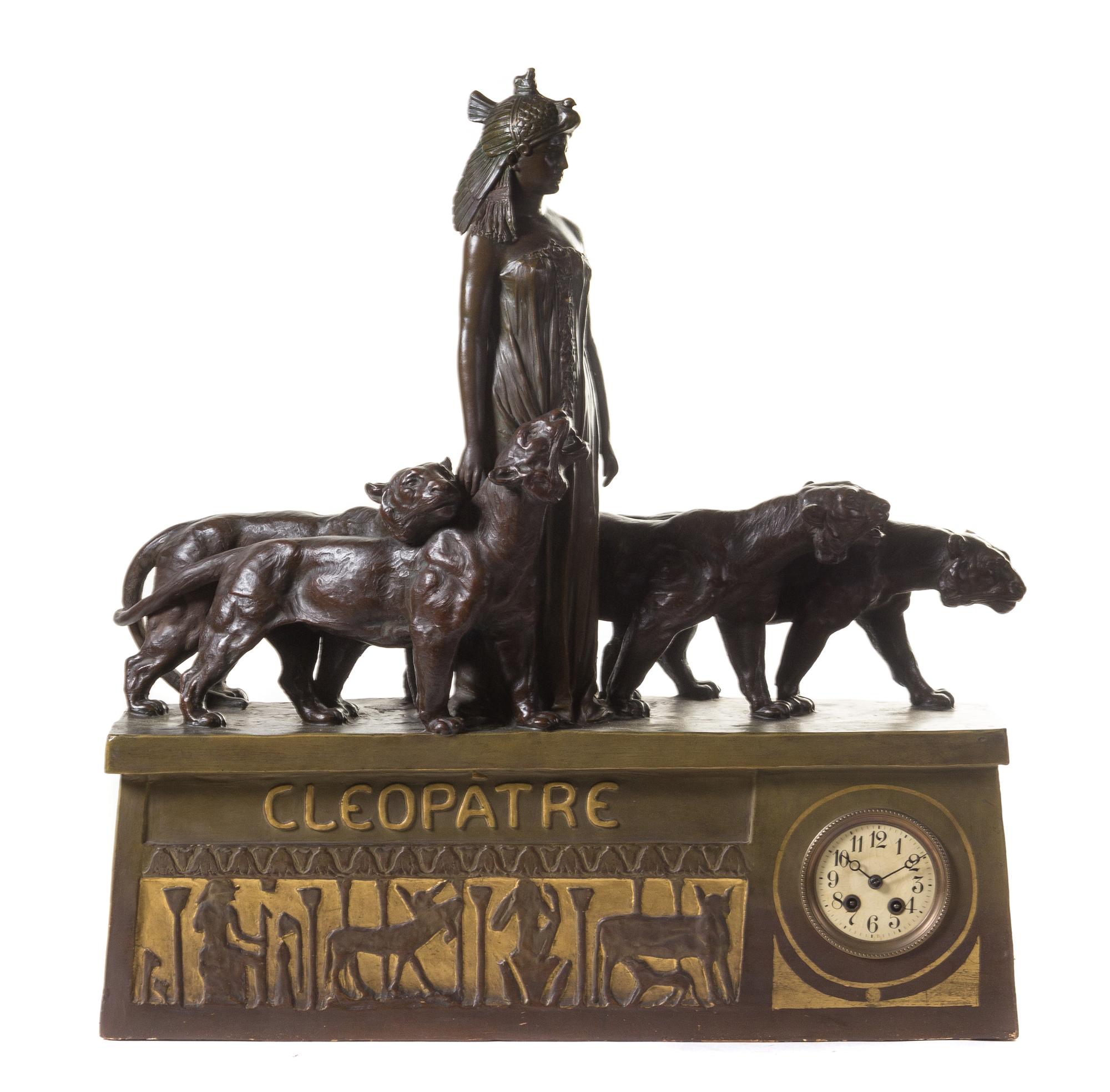 An Egyptian Revival Parcel Gilt Terra Cotta Figural Mantel Clock Height 28 x width 27 x depth 7 inches. — FRENCH, 19TH/20TH CENTURY