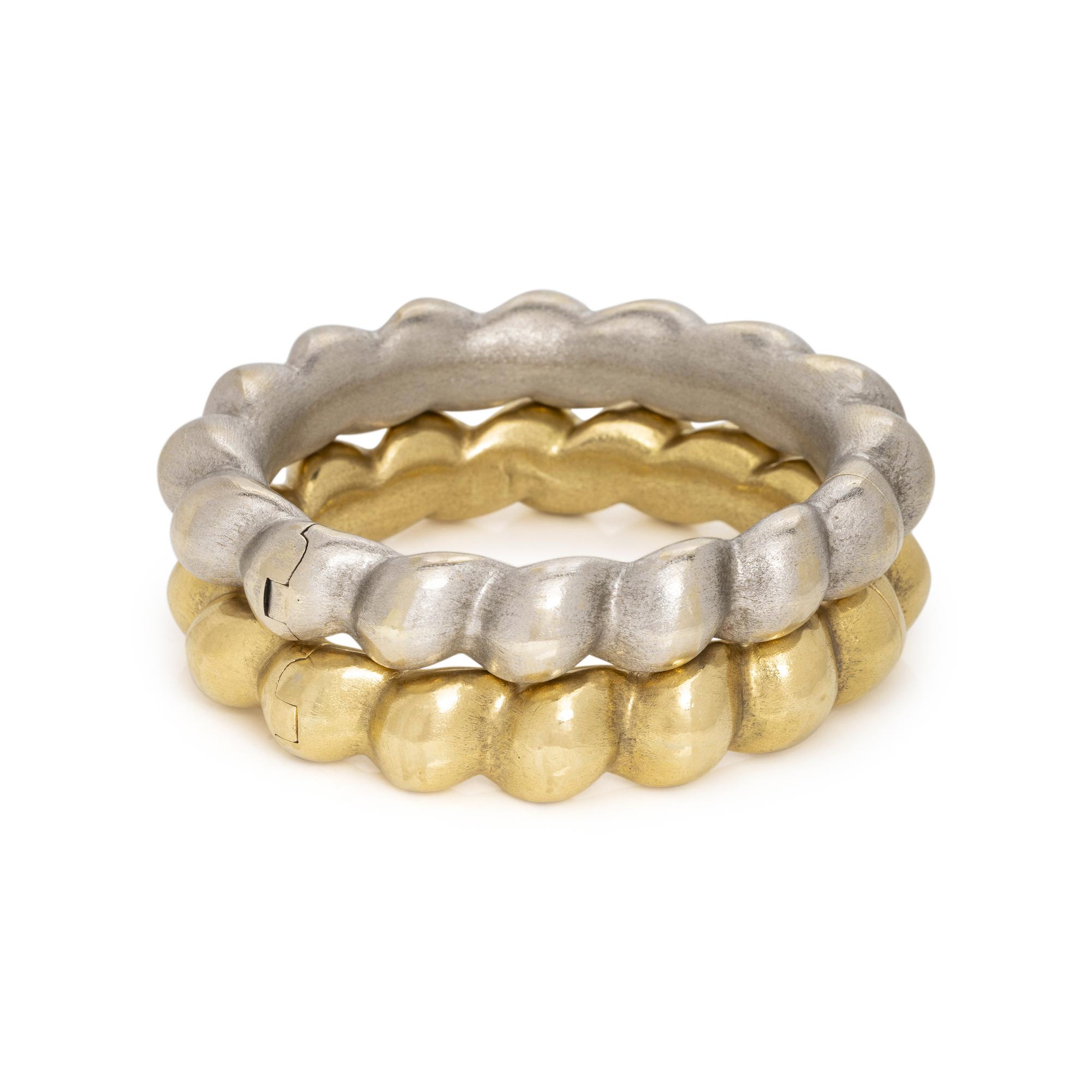 PAIR OF WHITE AND YELLOW GOLD BANGLE BRACELETS