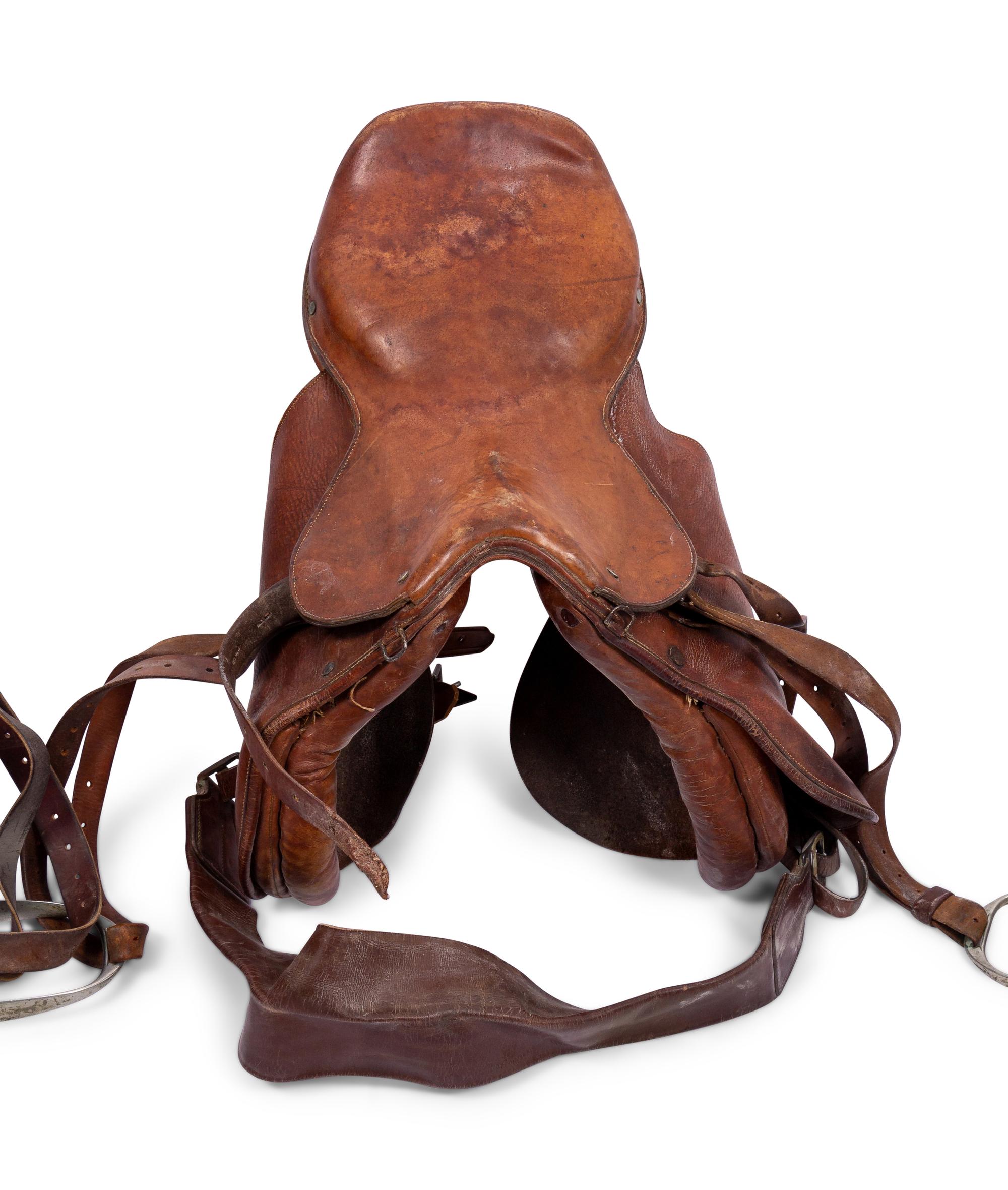 A Group of Three Leather Saddles, Including One by Abercrombie and Fitch