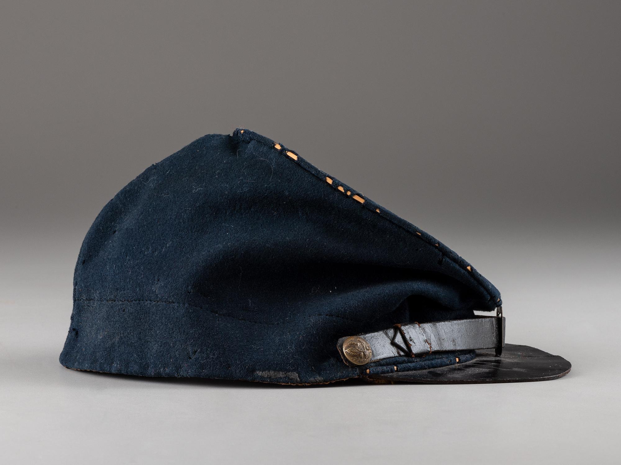 [CIVIL WAR]. Forage cap with contractor label featuring 104th regimental number and insignia.