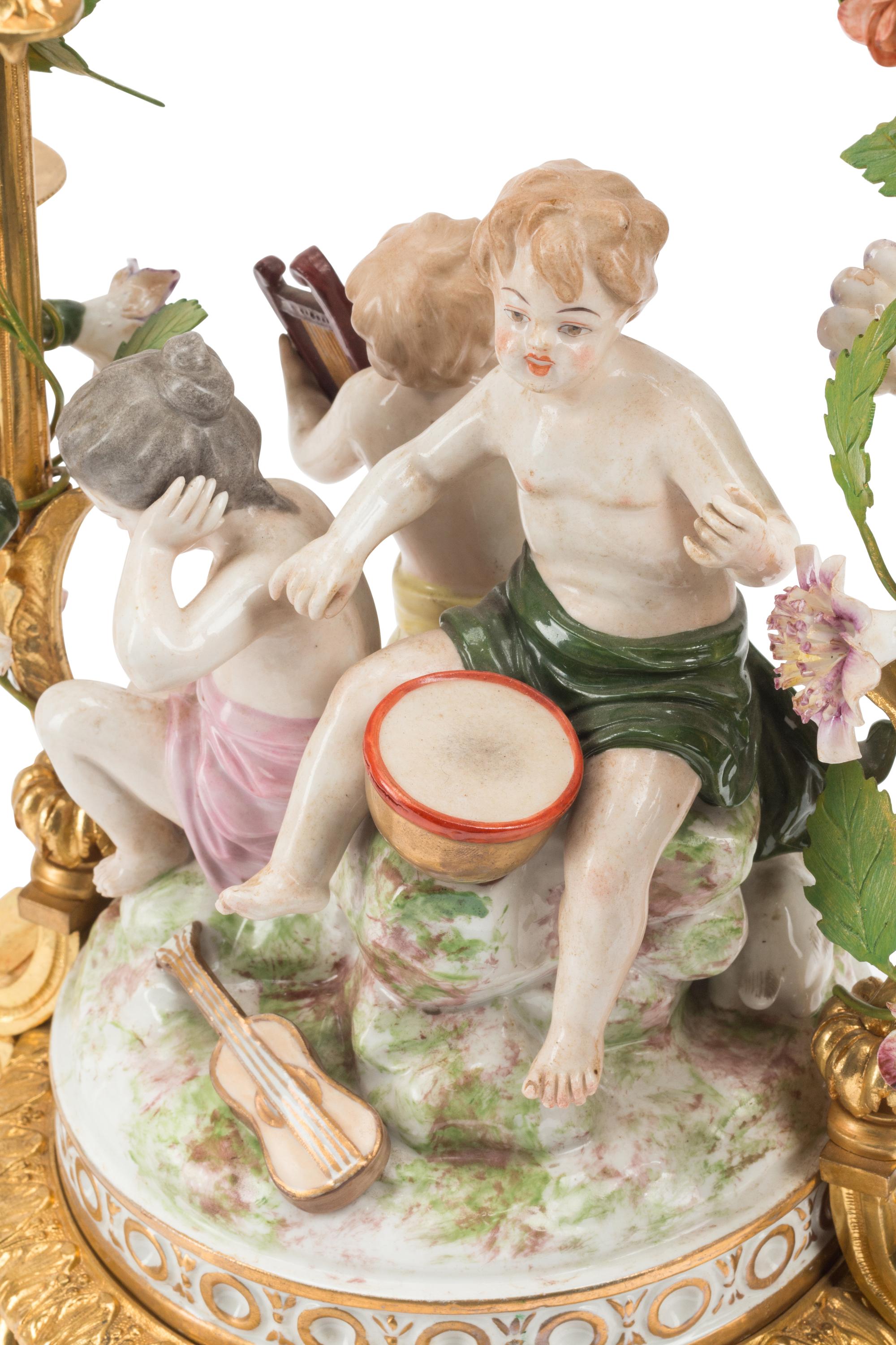 A Pair of French Gilt Bronze and Porcelain Figural Four-Light Candelabra