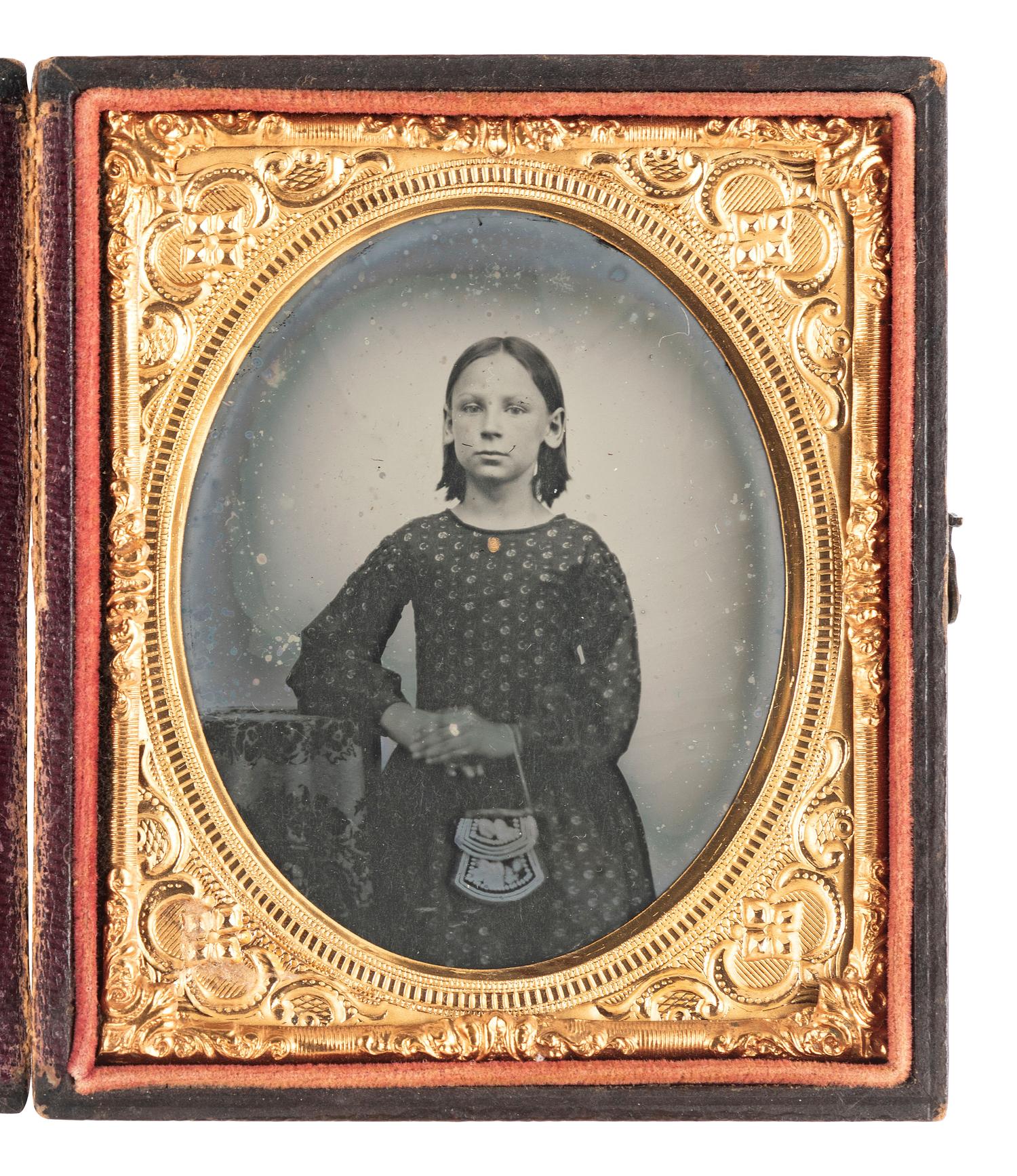 [EARLY PHOTOGRAPHY - NATIVE AMERICANS]. Sixth plate ambrotype of a young girl posed holding an Iroquois floral beaded pouch.