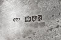 An Edwardian Silver Center Bowl, Elkington & Co., London, 1905, having three scroll handles.