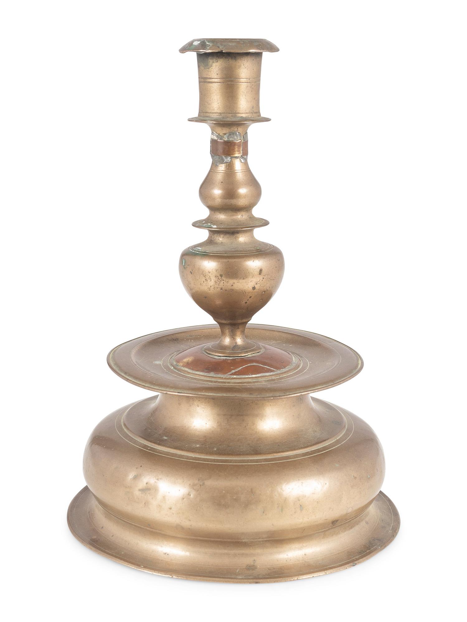 A Rare Continental Brass Bell-Bottom Candlestick