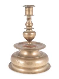 A Rare Continental Brass Bell-Bottom Candlestick