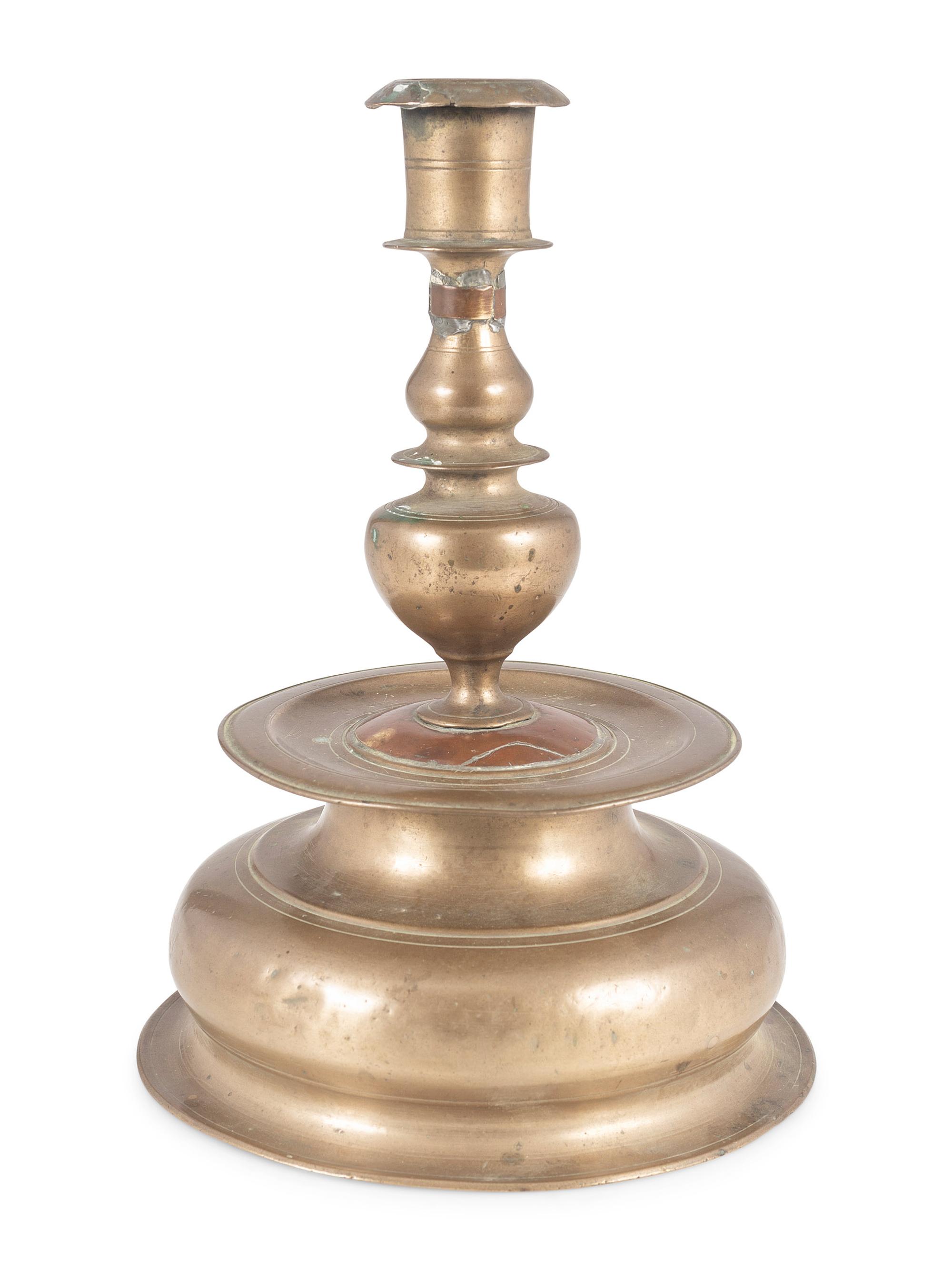 A Rare Continental Brass Bell-Bottom Candlestick