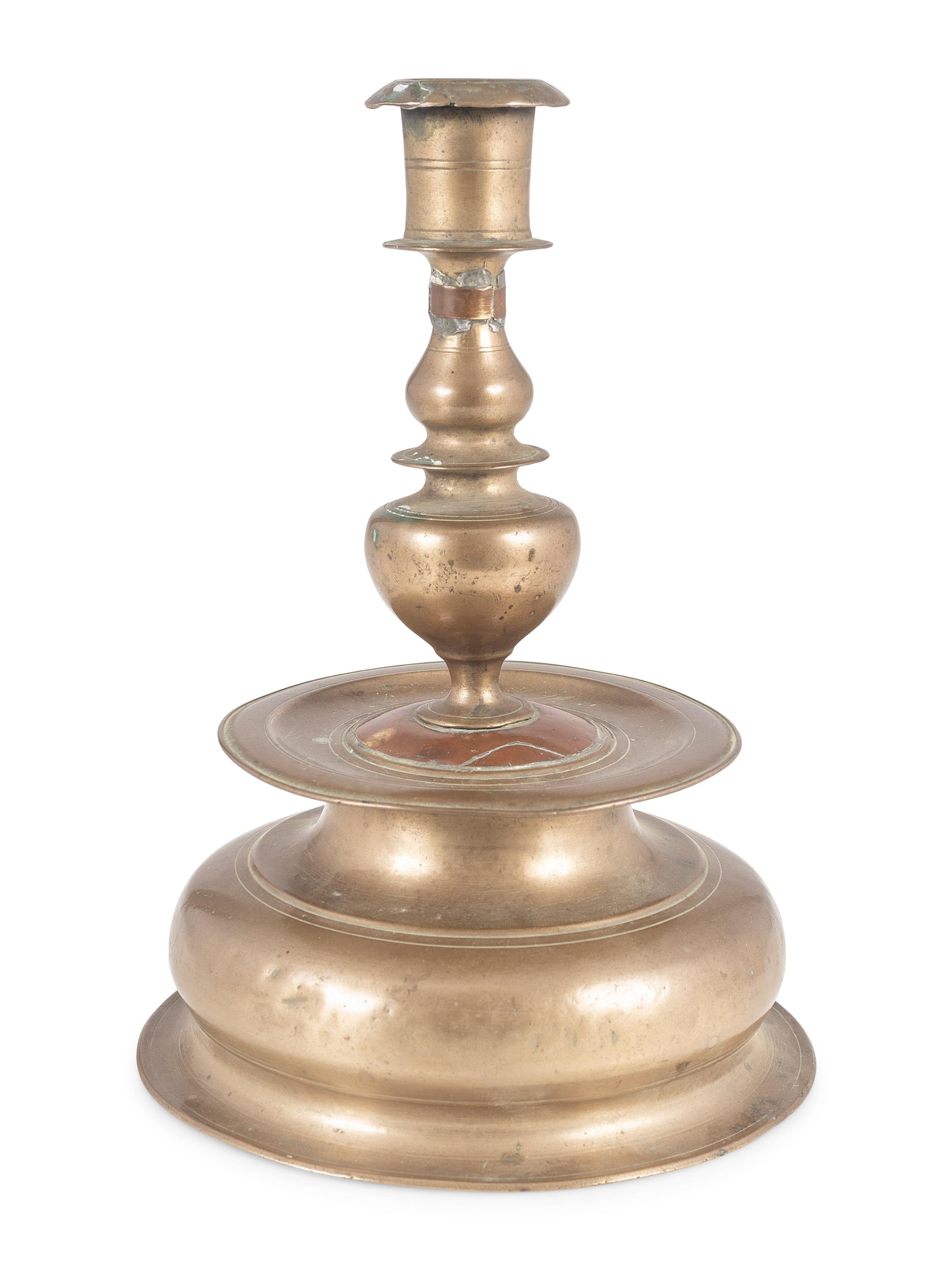A Rare Continental Brass Bell-Bottom Candlestick