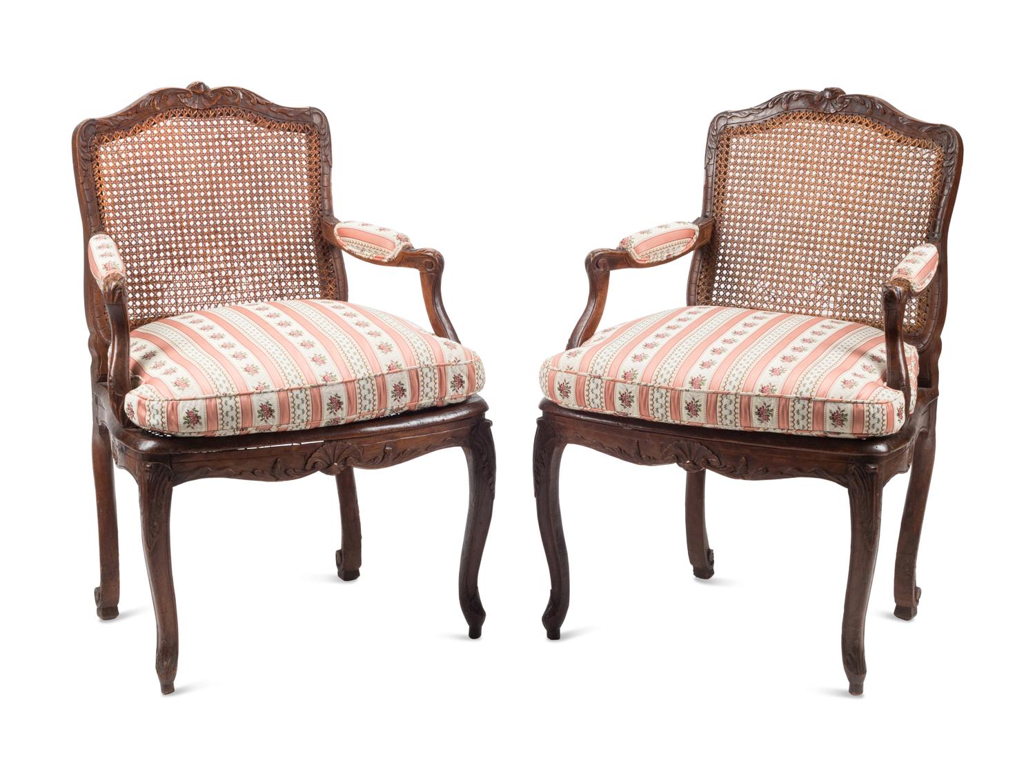 A Pair of Louis XV Provincial Walnut Caned Fauteuils