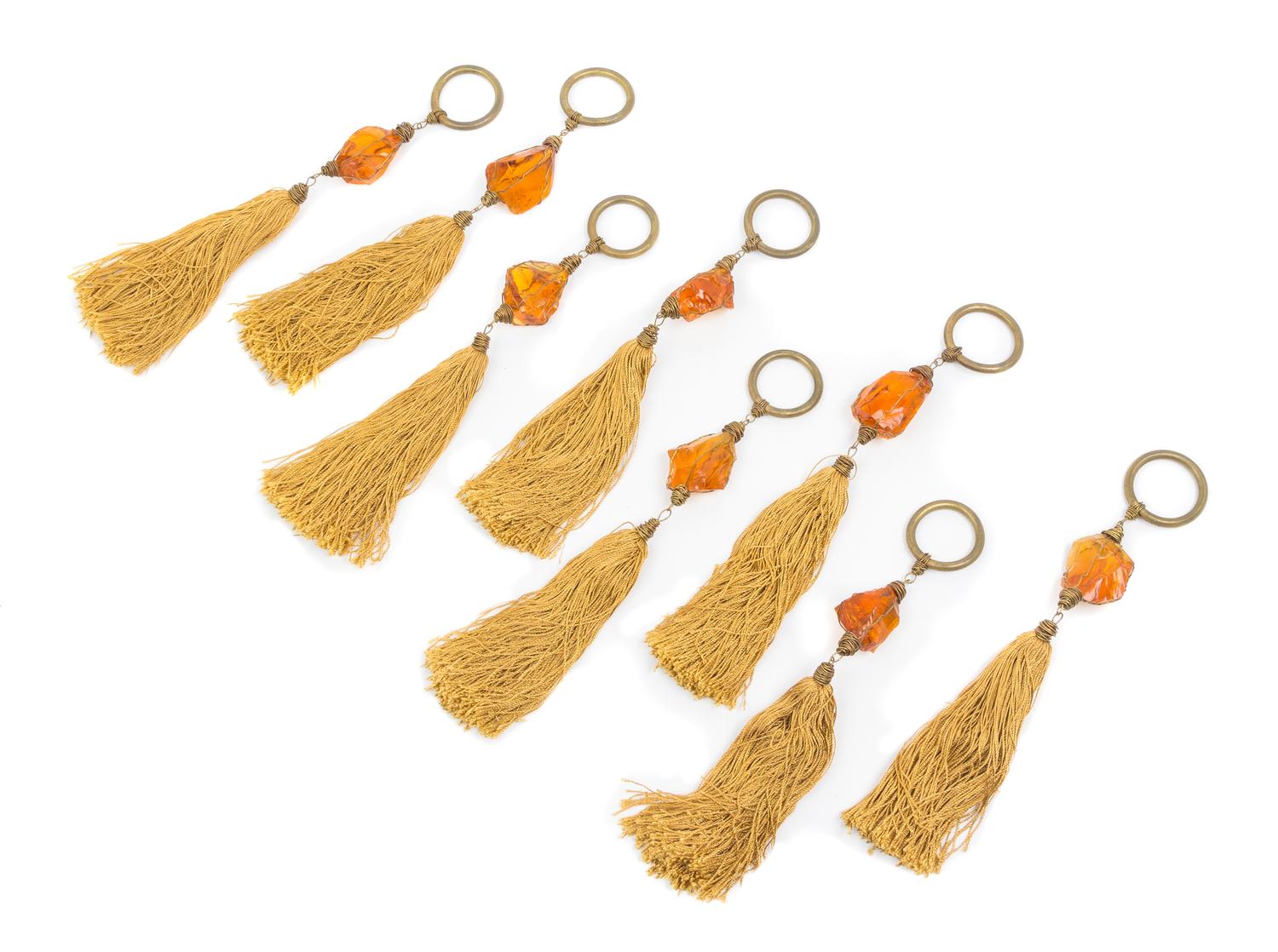 A Set of Sixteen Amber Drapery Ornaments Length 12 1/4 inches.