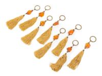 A Set of Sixteen Amber Drapery Ornaments Length 12 1/4 inches.