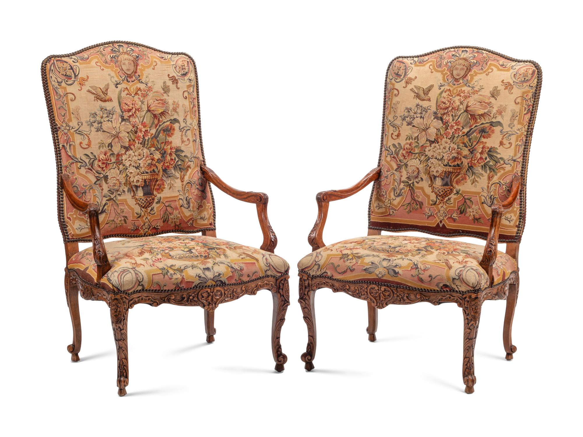A Pair of Régence Style Carved Walnut and Tapestry-Upholstered Armchairs