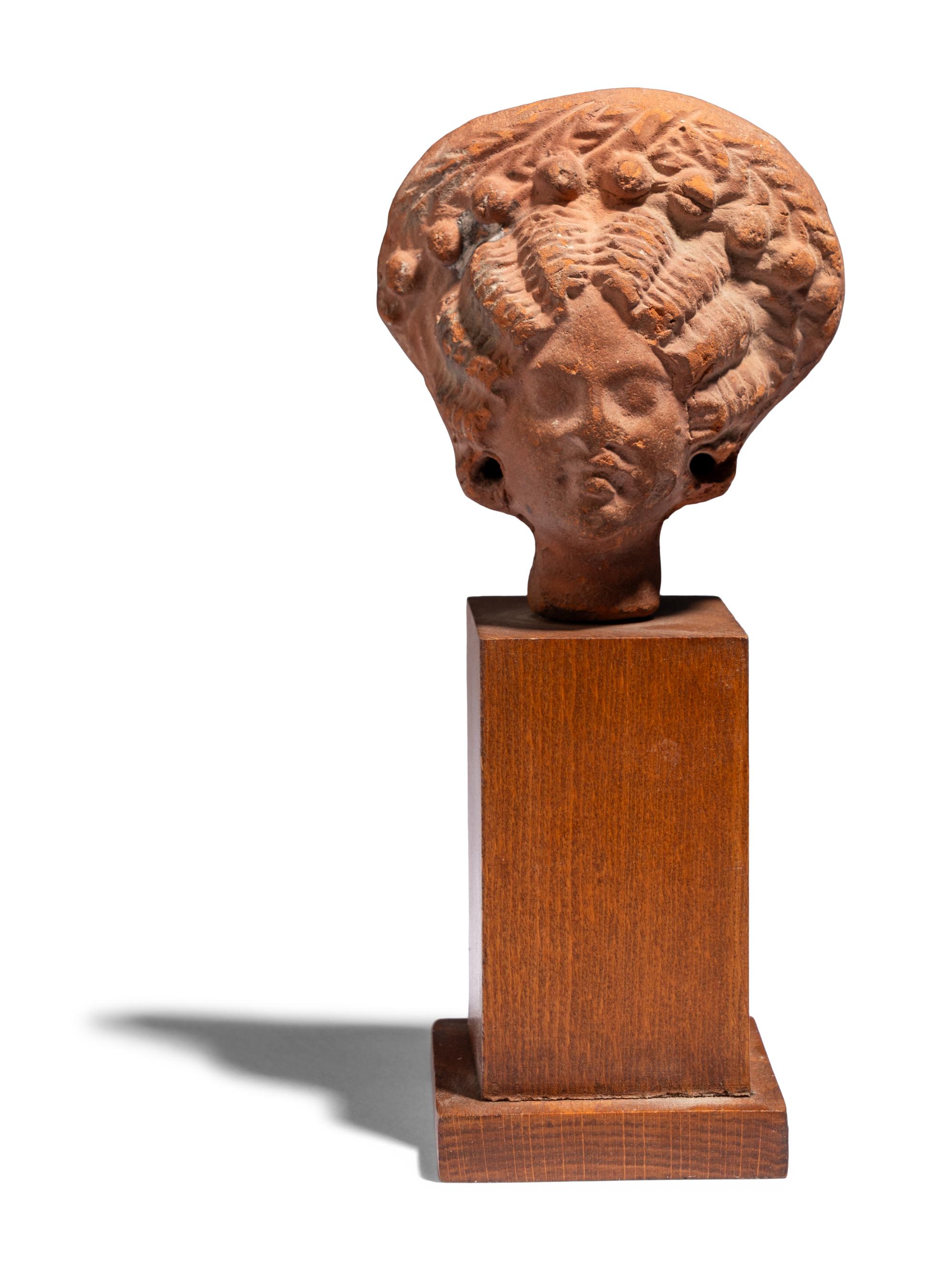 An Egyptian Terracotta Head of a Woman