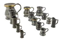 A Collection of Pewter and Mixed Metal Measuring Beakers Height of tallest 6 inches.