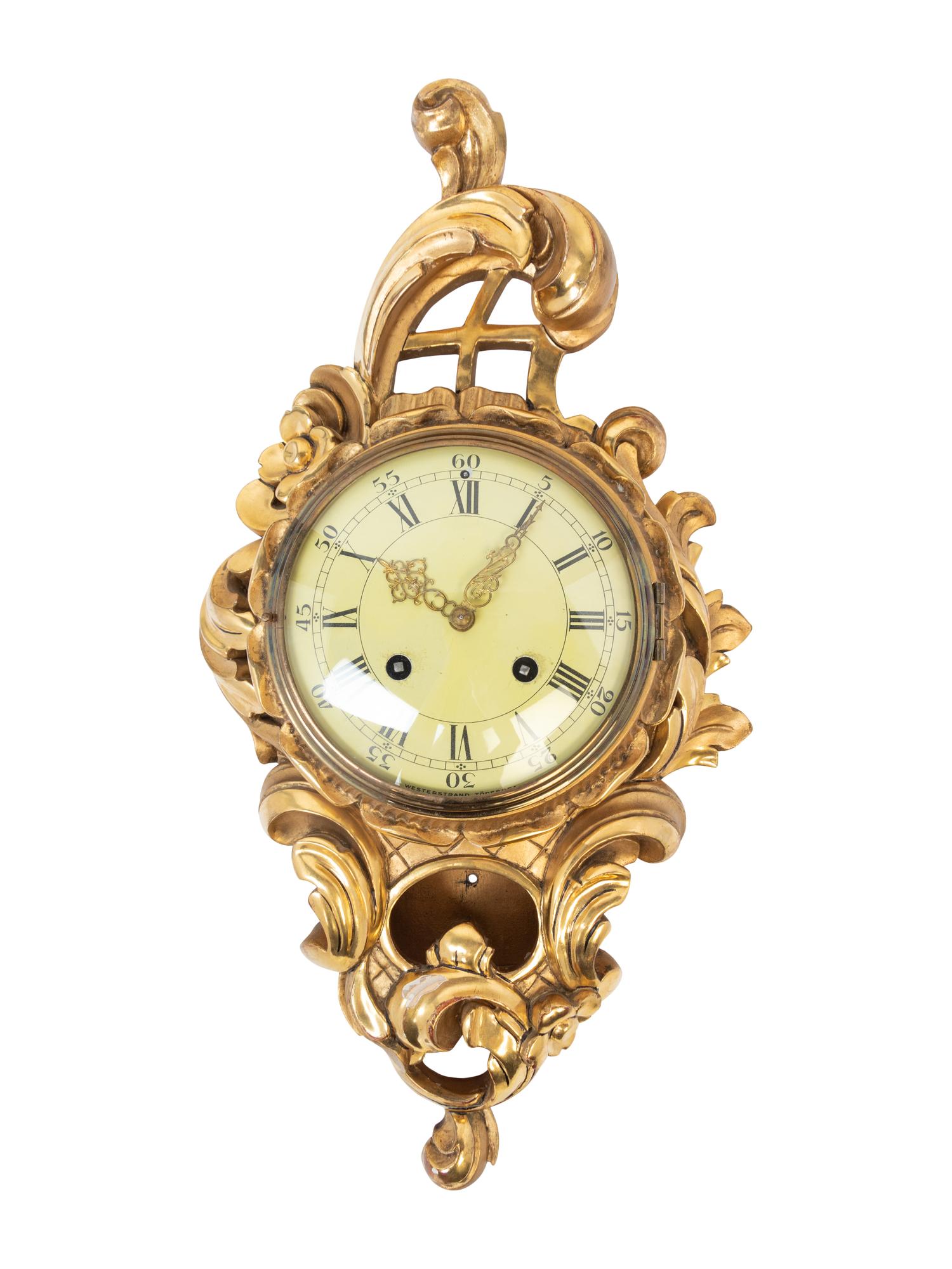 A Rococo Style Giltwood Cartel Clock