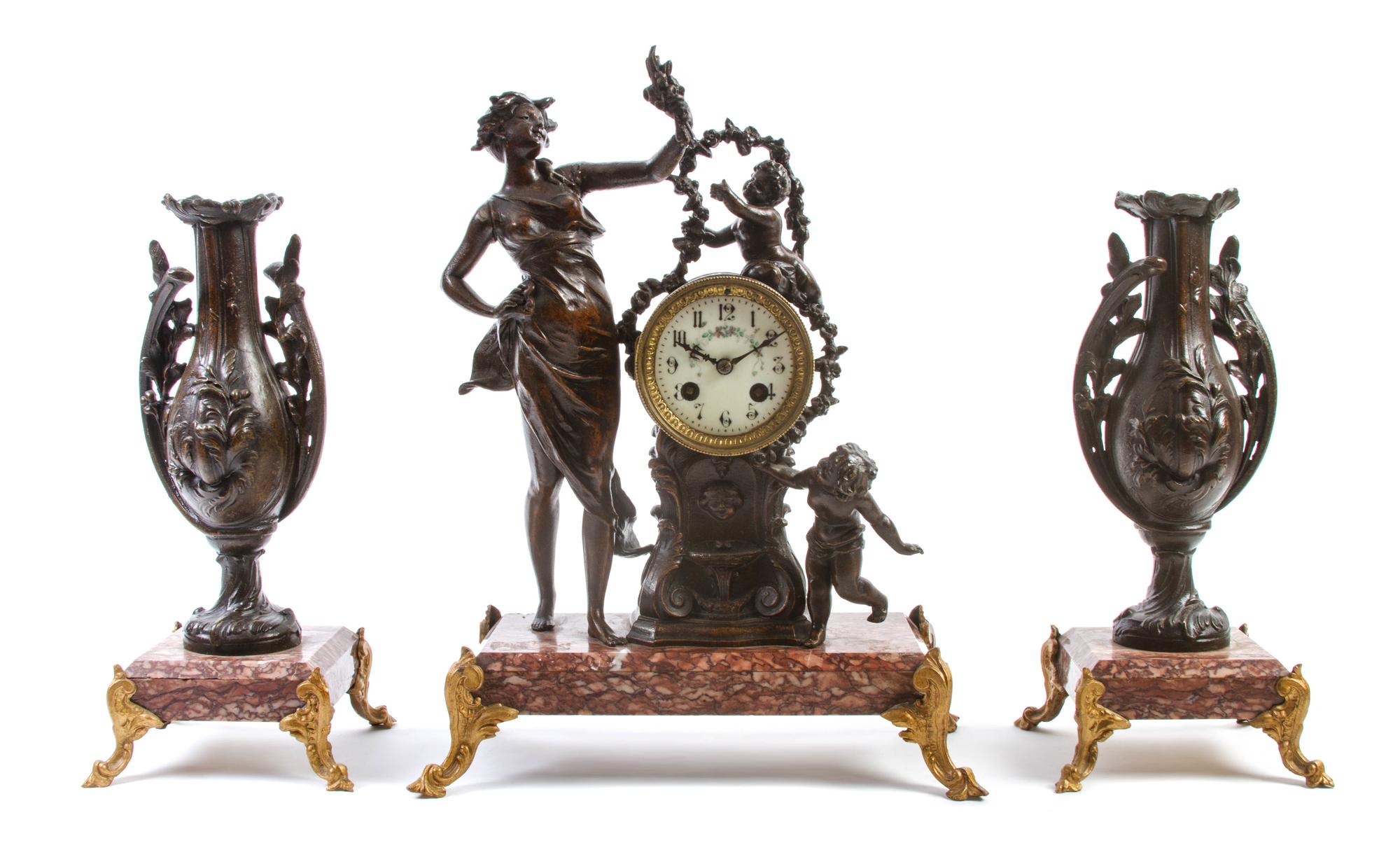A Continental Patinated Metal and Marble Clock Garniture, Height of clock 16 inches.