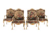 A Set of Four Louis XV White-Painted and Parcel Gilt Tapestry-Upholstered Fauteuils
