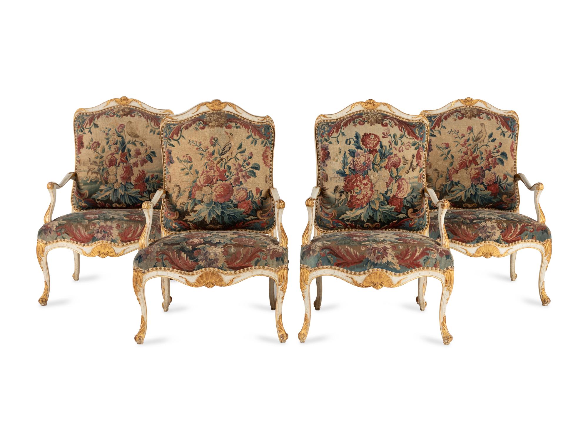 A Set of Four Louis XV White-Painted and Parcel Gilt Tapestry-Upholstered Fauteuils
