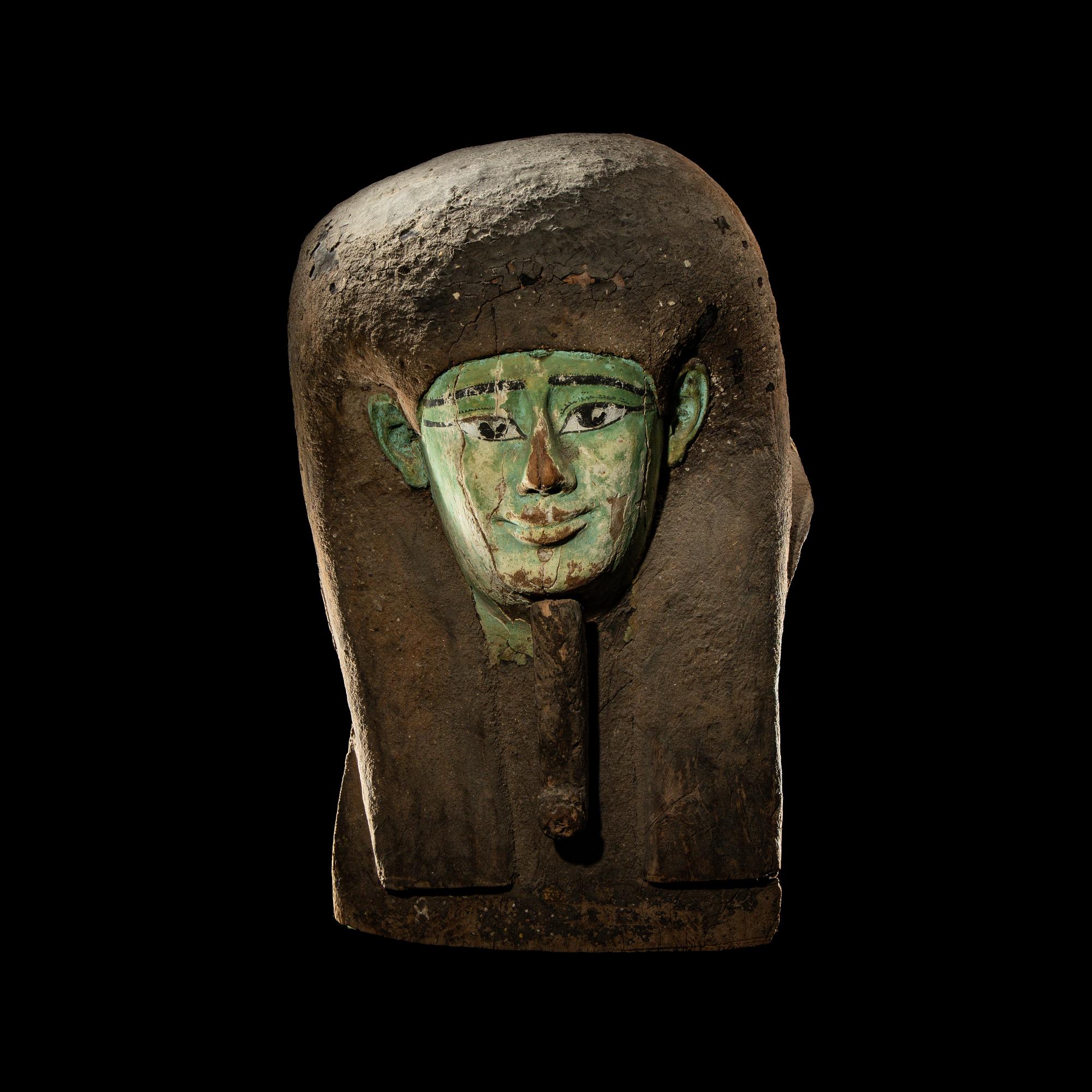 An Egyptian Painted Wood Sarcophagus Head