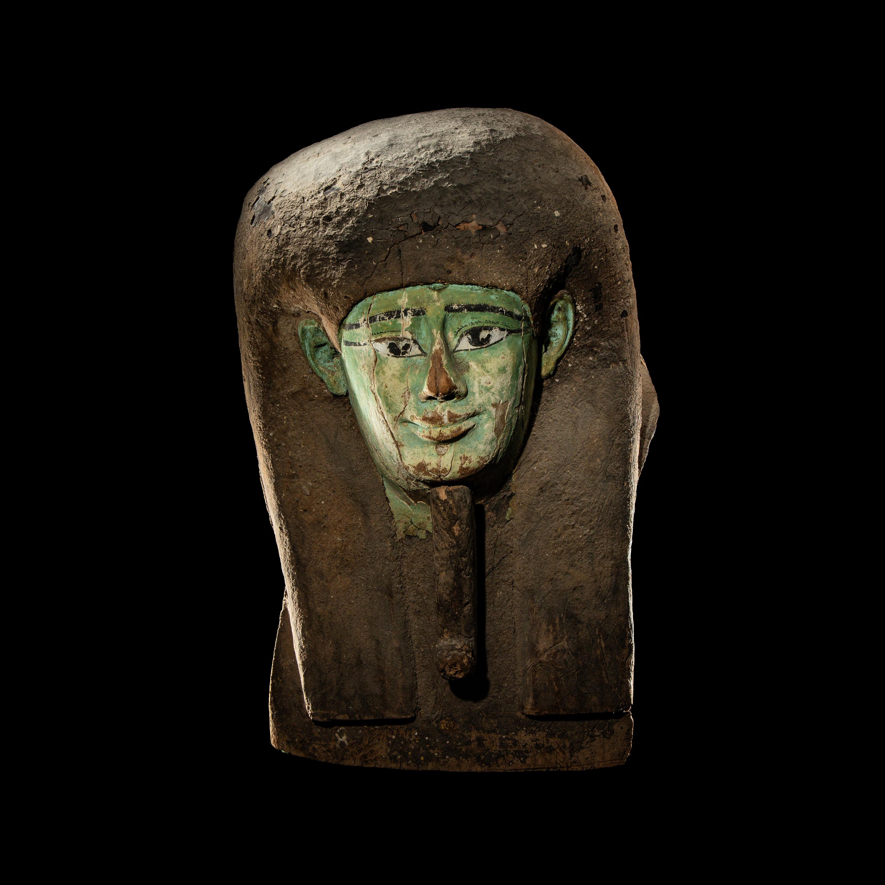 An Egyptian Painted Wood Sarcophagus Head