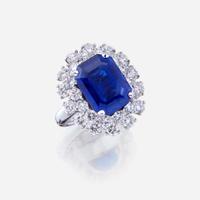 A sapphire, diamond, and fourteen karat white gold ring
