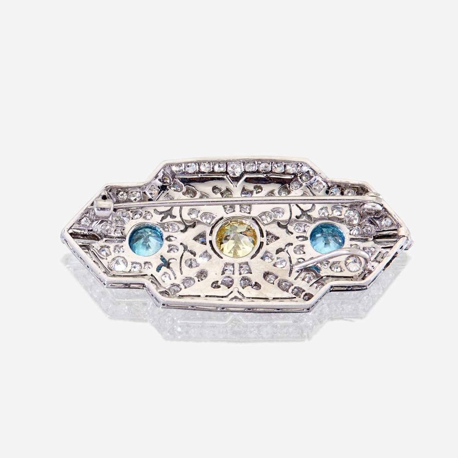 A yellow diamond, diamond, zircon, and fourteen karat white gold pendant/brooch, Raymond Yard