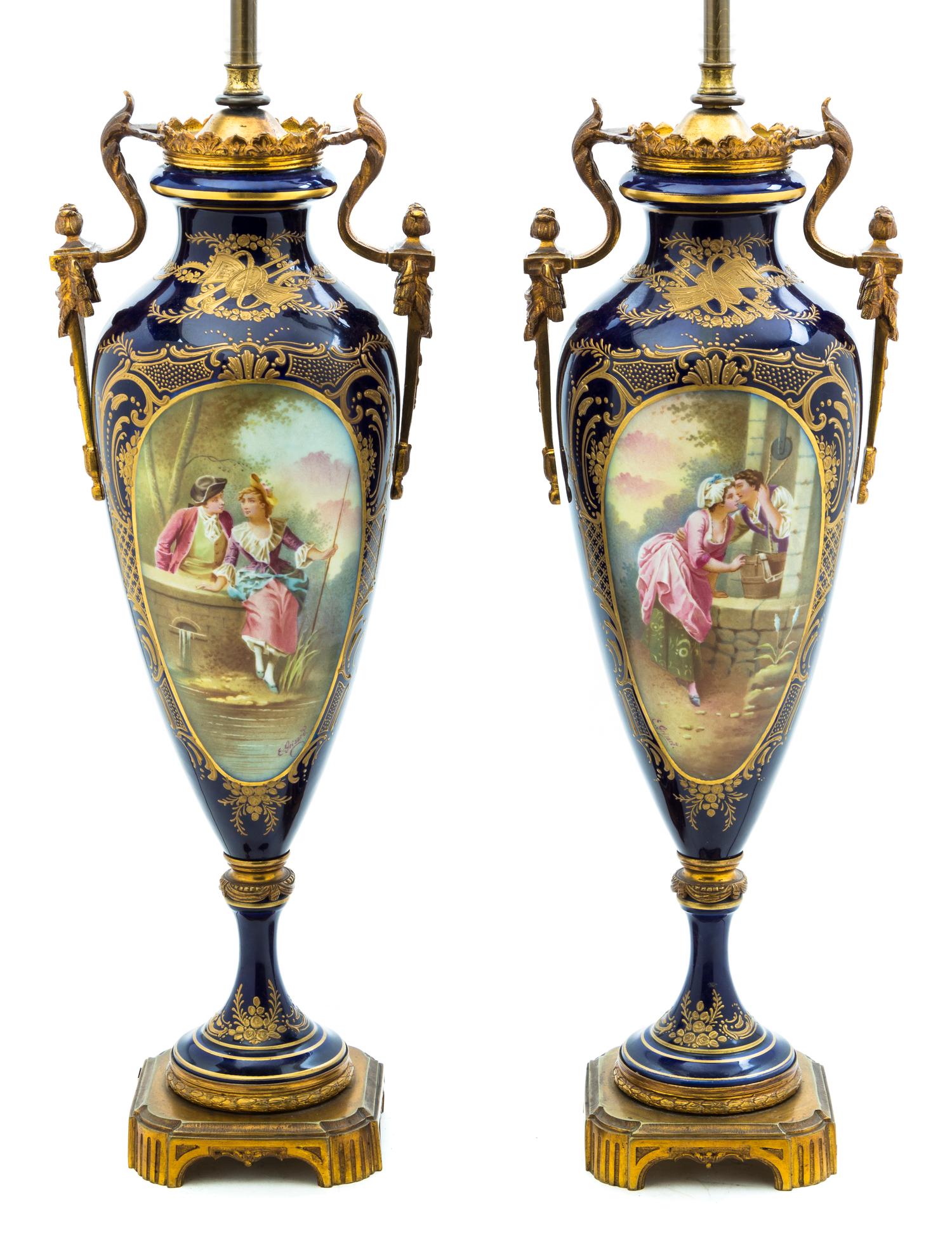 A Pair of Sevres Style Porcelain and Gilt Bronze Mounted Urns, Height 18 inches.