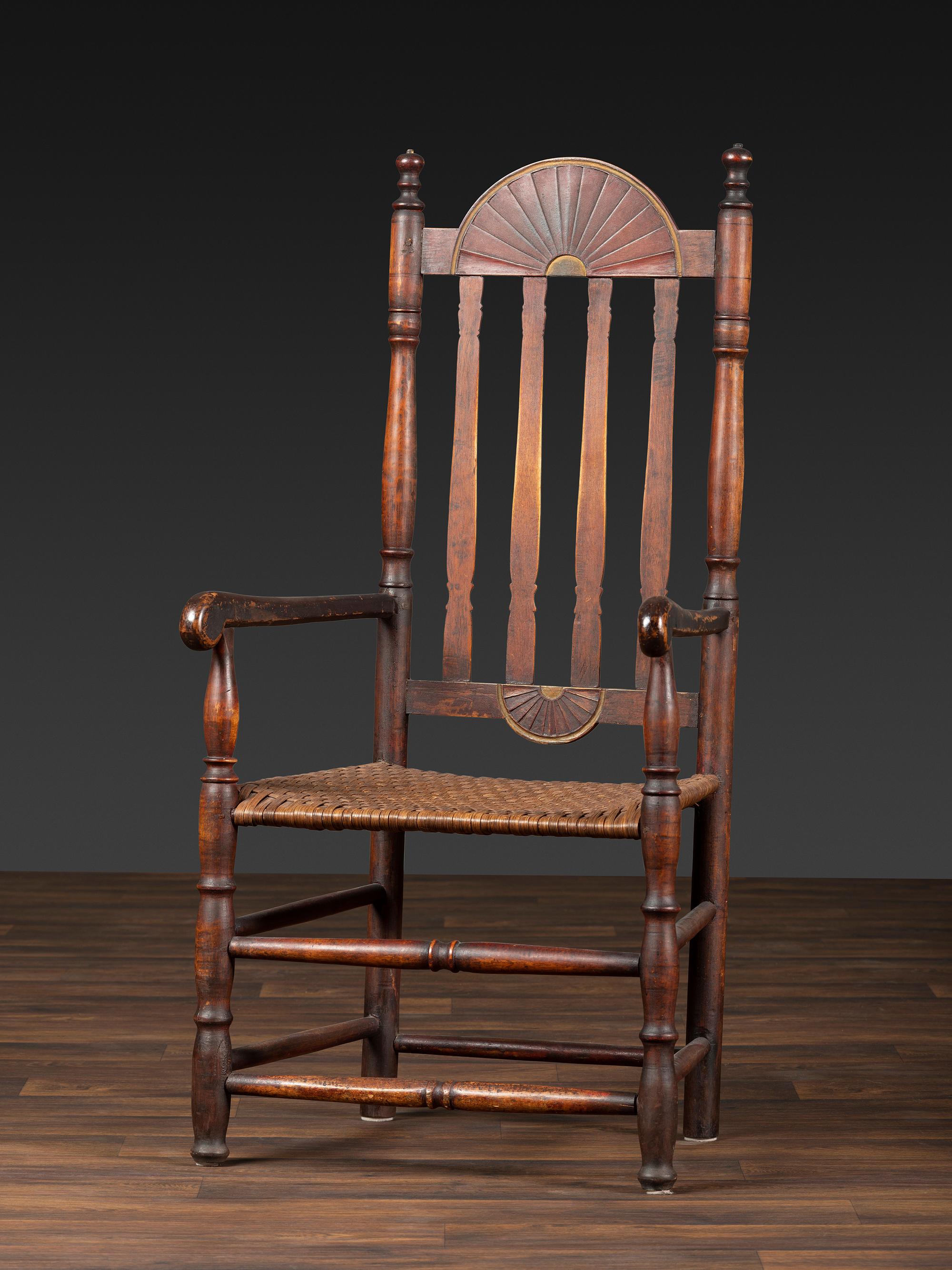 A William and Mary Style Parcel Gilt and Red Painted, Fan-Carved Bannister Back Woven Splint Seat Armchair