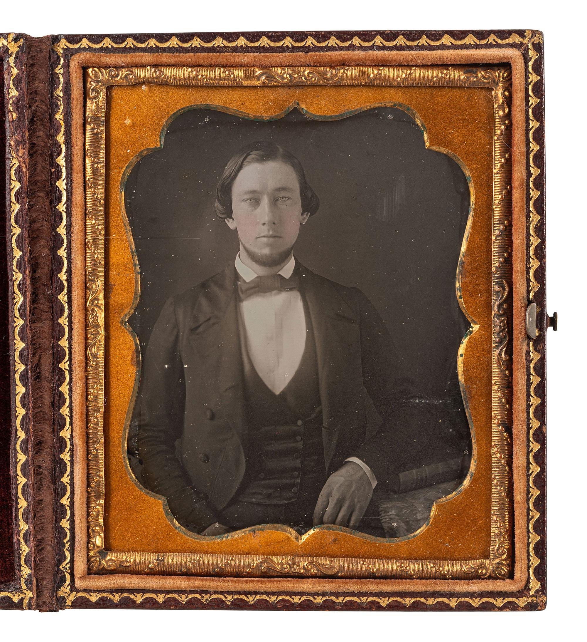 [EARLY PHOTOGRAPHY]. 2 daguerreotypes of men in cases bearing British emblems.