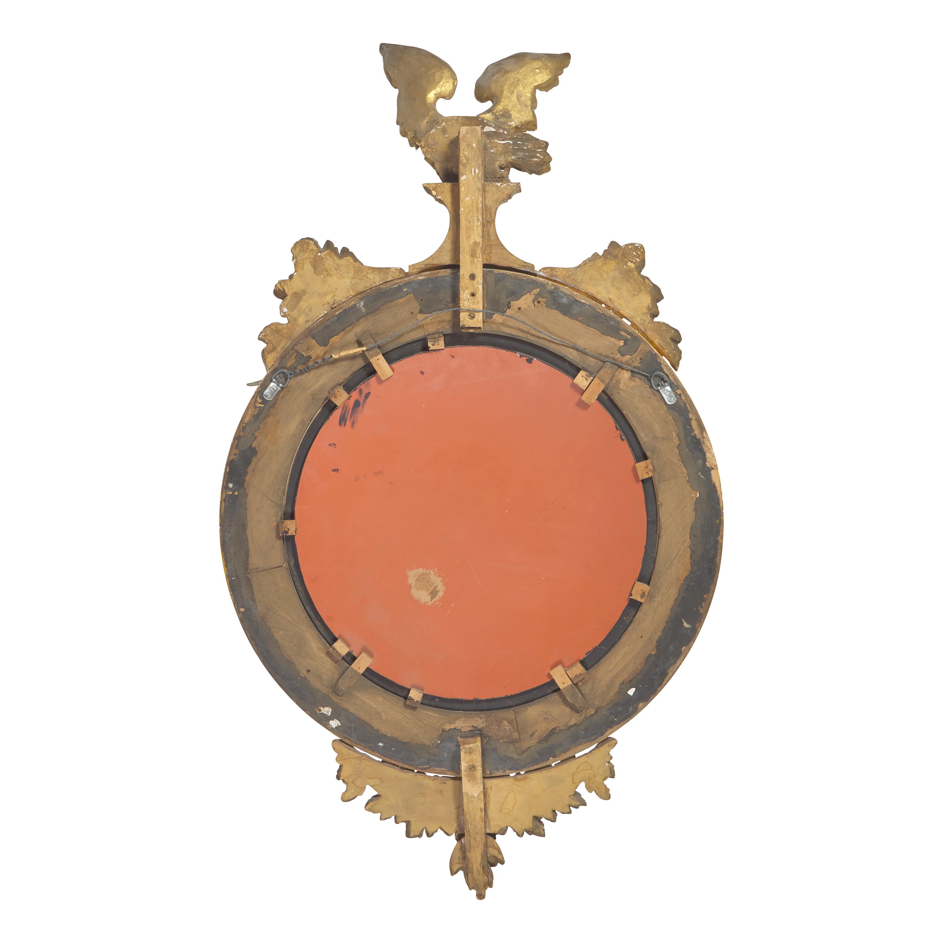 A Classical Giltwood and Parcel Ebonized Bull's Eye Mirror with Eagle