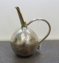 A Greek Silver Wine Jug, Michalas, Athens, the body of globular form with a spot hammered finish having a handle connecting to a gilt-s