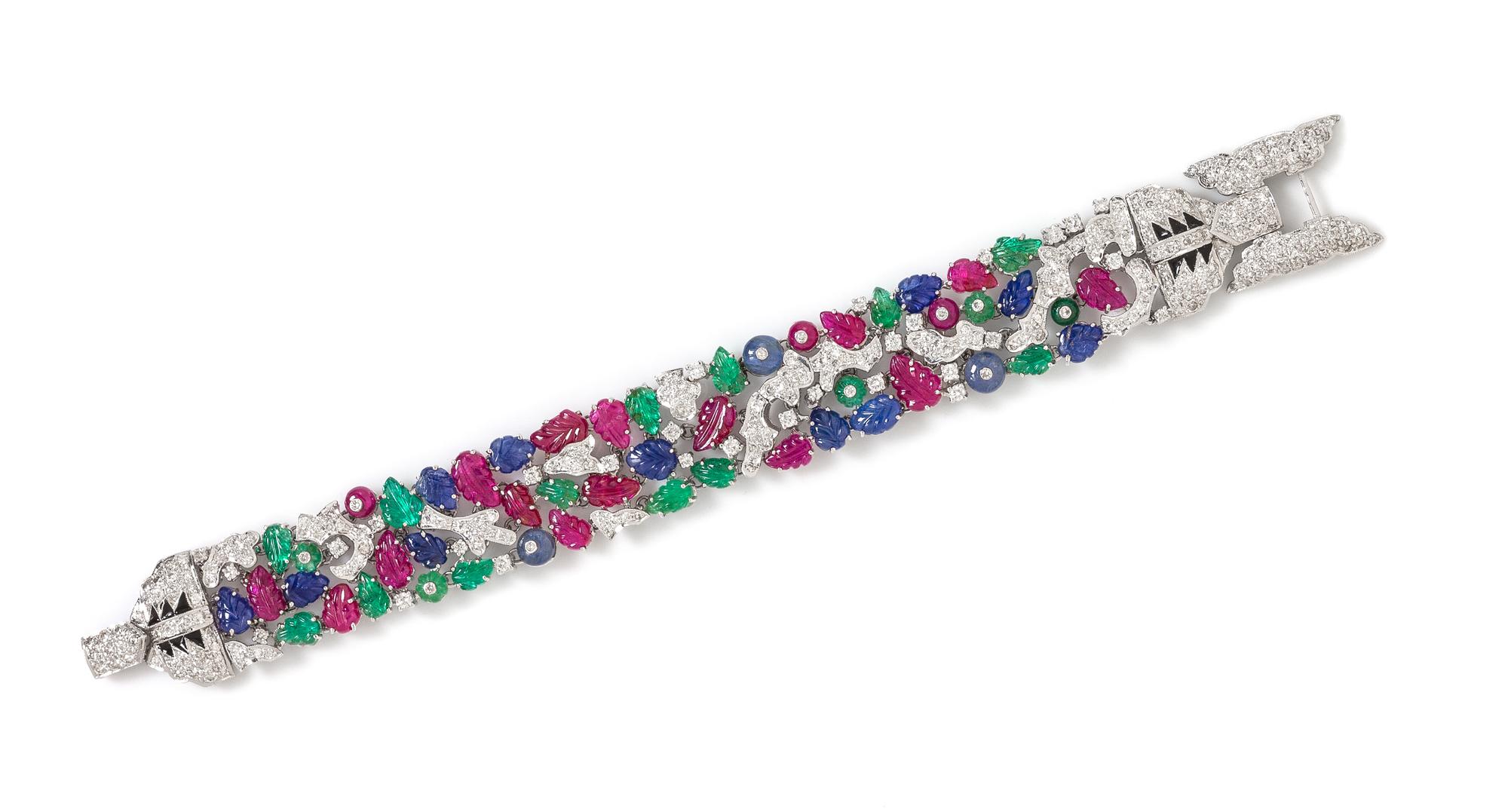 A White Gold, Diamond, Carved Ruby, Sapphire and Emerald Bracelet, 40.20 dwts.