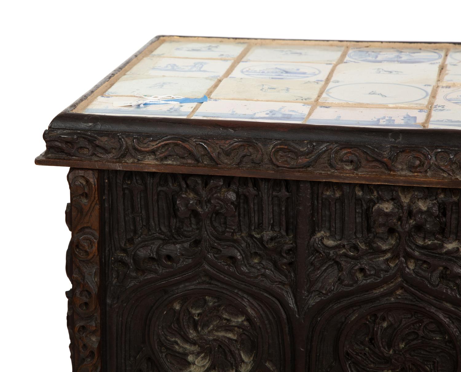 A Gothic Revival Carved Oak Tile-Mounted Chest on Stand