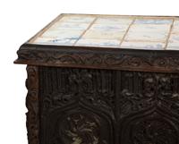 A Gothic Revival Carved Oak Tile-Mounted Chest on Stand
