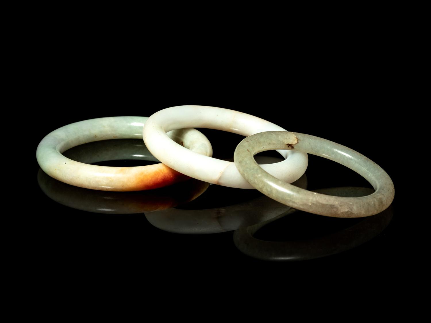 Three Chinese Jadeite and Hardstone Bangles