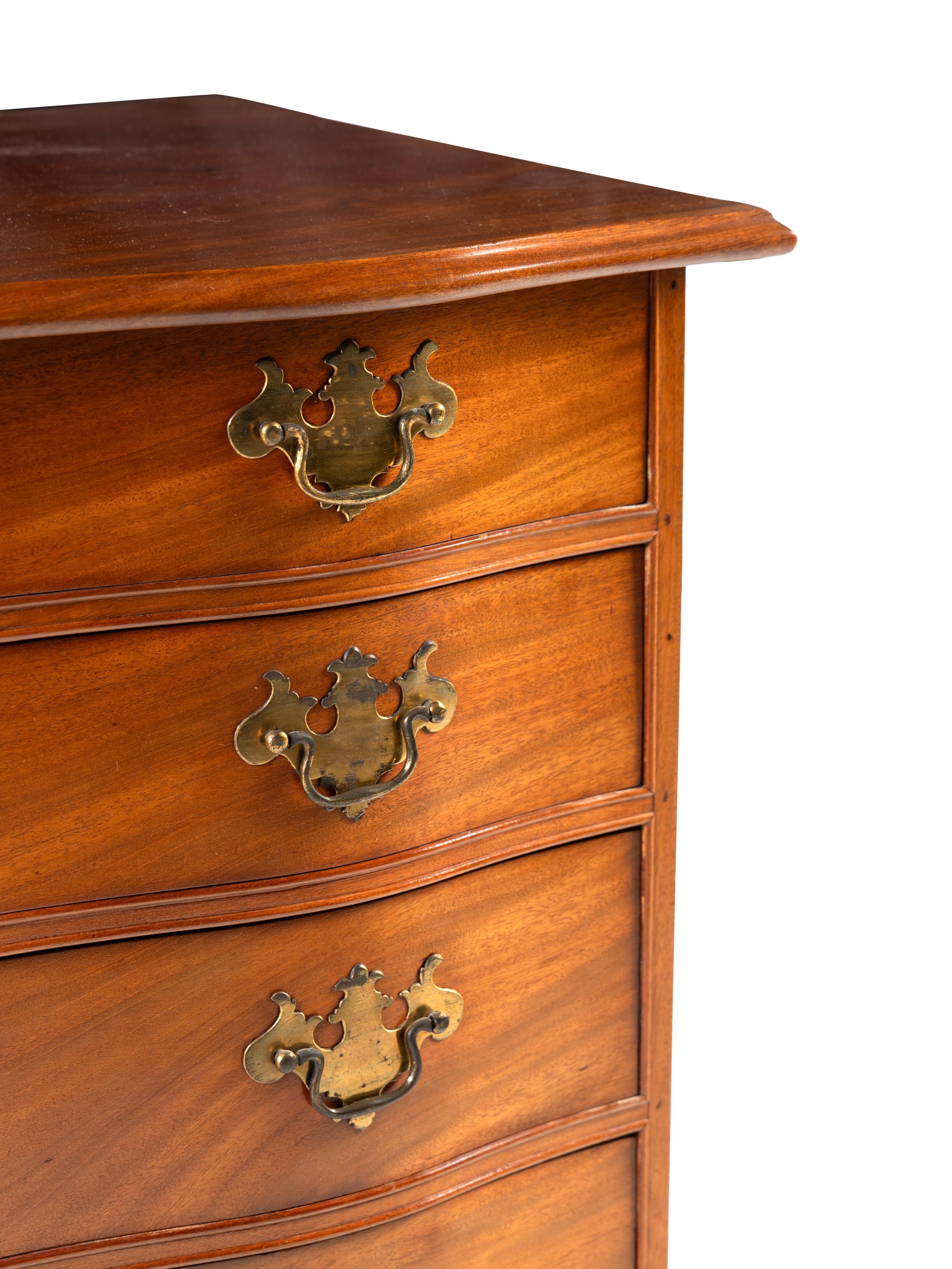 A Chippendale Carved And Figured Mahogany Serpentine Chest Of Drawers