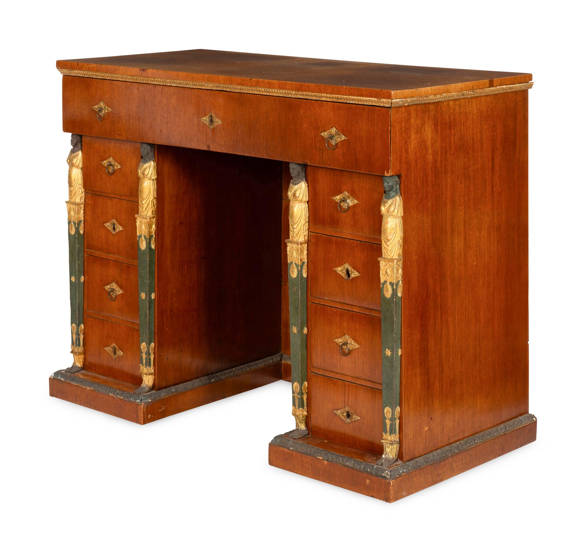 A Continental Empire Style Painted and Parcel-Gilt Mahogany-Veneered Kneehole Desk