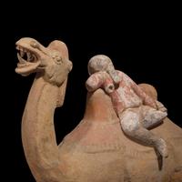 A Chinese Painted Pottery Figural Group of a Camel and a Rider, Possibly Tang Dynasty — 或為唐 陶加彩駱駝俑