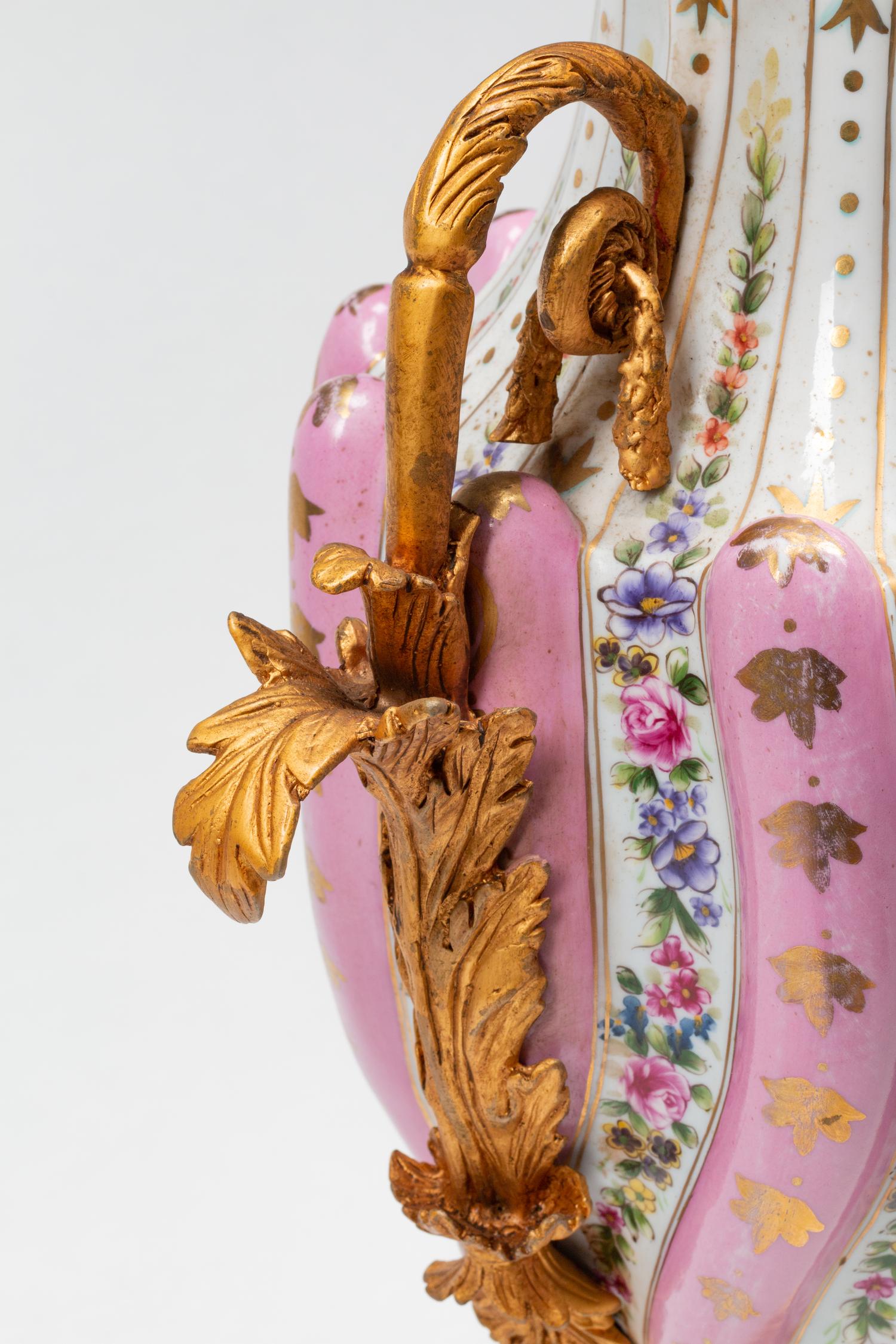 A Pair of Sèvres Style Gilt Bronze Mounted Porcelain Urns