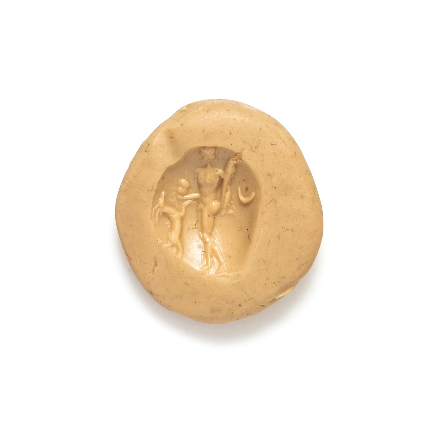 A Roman Carnelian Intaglio with the God Dionysus Teasing a Goat with Grapes