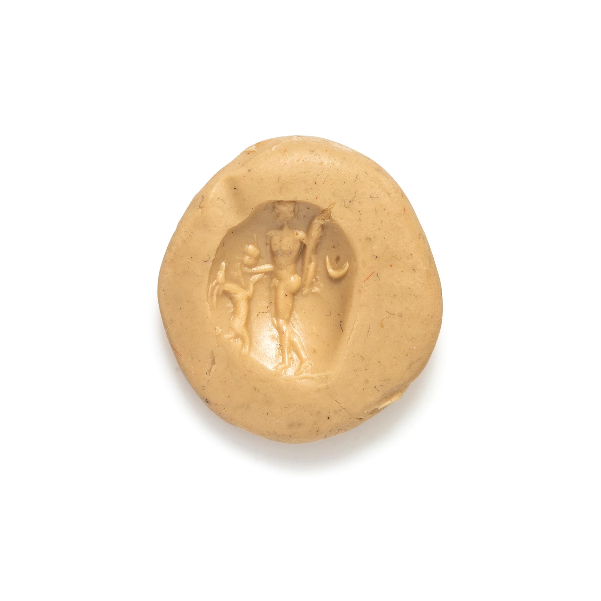 A Roman Carnelian Intaglio with the God Dionysus Teasing a Goat with Grapes