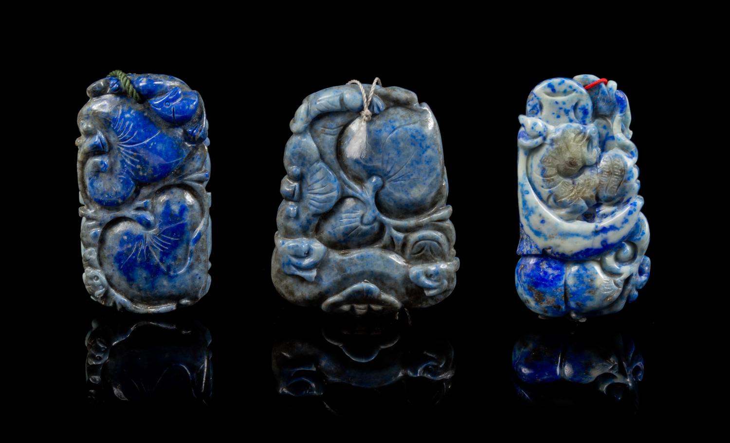 A Group of Three Carved Lapis Lazuli Pendants Length of first 2 5/8 inches.