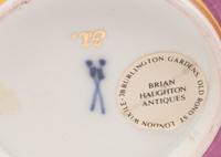 A Pair of Meissen Magenta-Ground Scenic Porcelain Teacups and Saucers