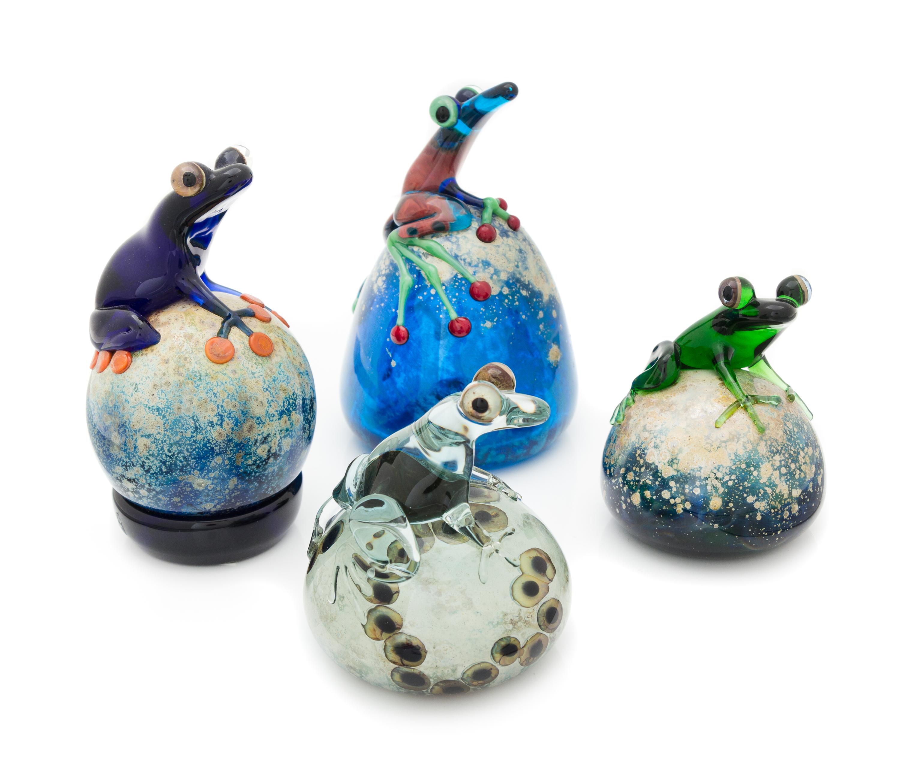 John Nygren, (American), a group of four paperweights, each with applied frog decoration