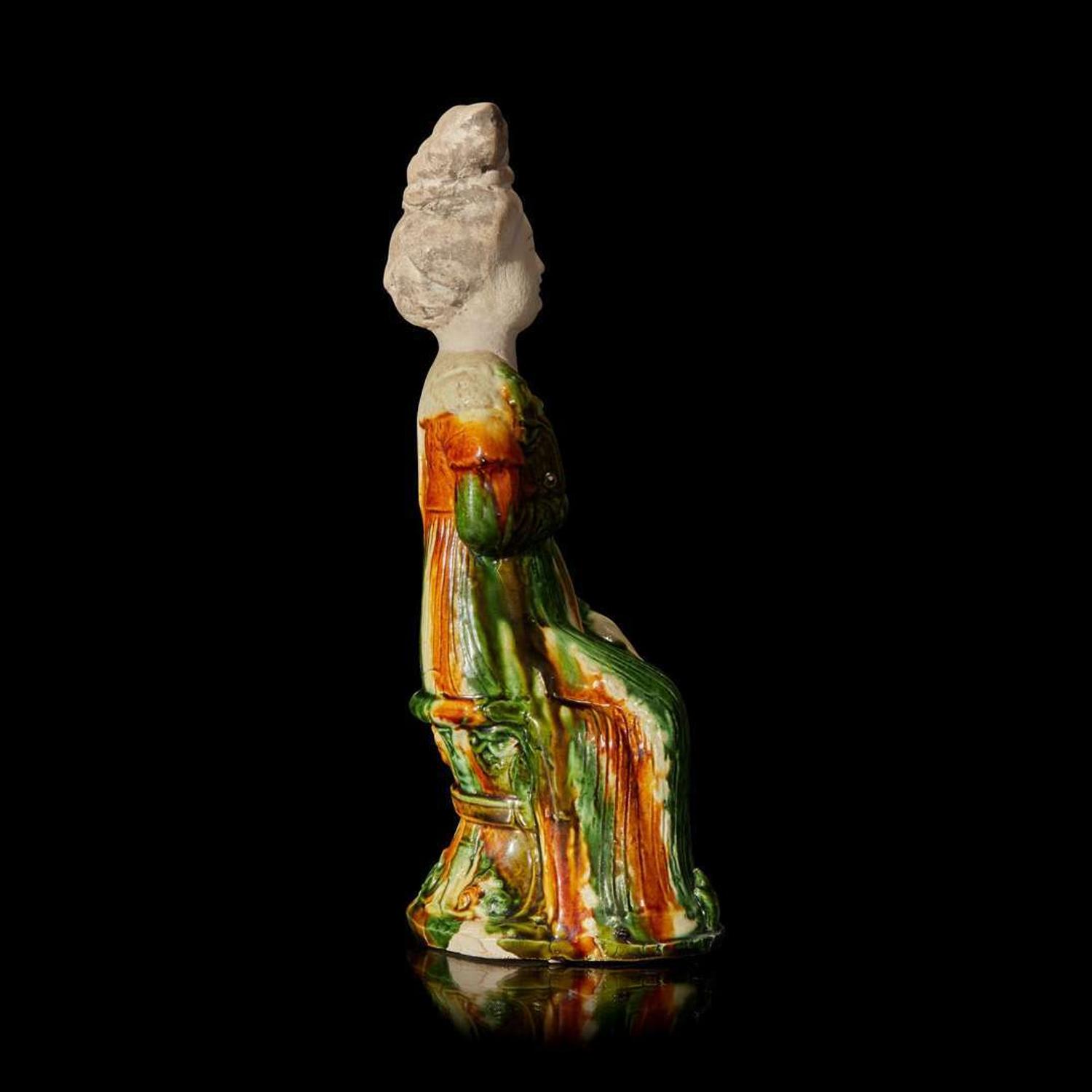 A Chinese sancai-glazed pottery figure of a seated woman 唐三彩仕女坐像 Tang dynasty ?